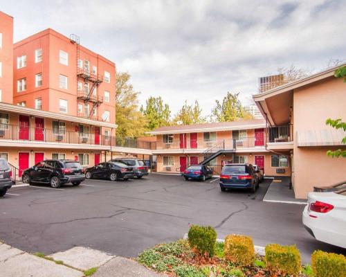 a parking lot with cars parked in front of buildings at Econo Lodge Portland Downtown in Portland