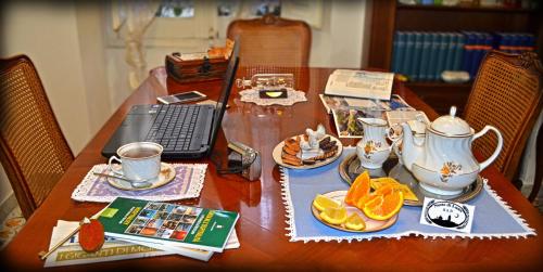 una mesa de madera con un set de té encima en Notte di Luna room & breakfast, en Oristano