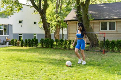 a young girl playing with a soccer ball in a yard at AQUA HOUSE in Sopot