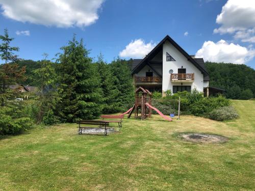 a house with a playground in the yard at SOBEL II in Tylmanowa