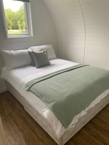 a bed in a room with a window at Luxury Pod Cabin in beautiful surroundings Wrexham in Wrexham