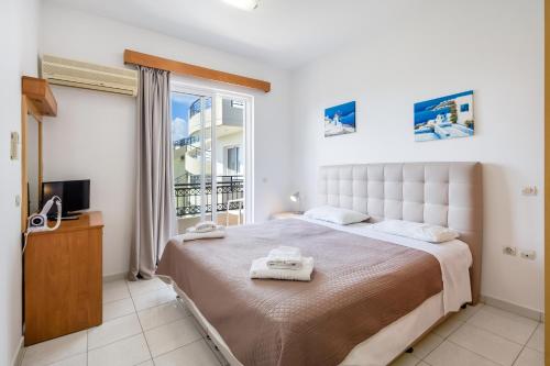 Ένα ή περισσότερα κρεβάτια σε δωμάτιο στο Johnhara Studios & Apartments 