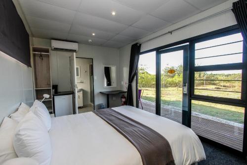 a bedroom with a large bed and a large window at SleepOver KMIA in White River