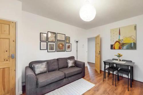 a living room with a couch and a table at Central & Cosy 2BD Flat near Canary Wharf in London