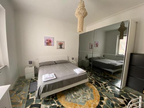 a bedroom with a large bed and a mirror at La perla in Chiavari