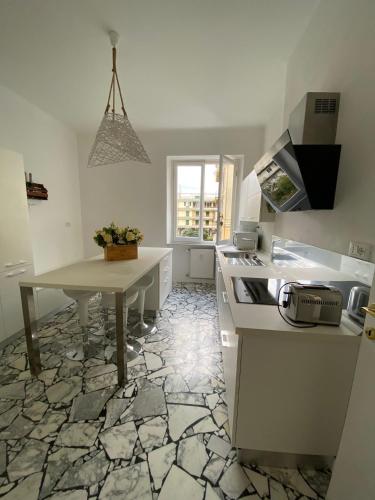 a kitchen with a table and a counter top at La perla in Chiavari