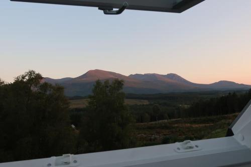 a view of mountains from the back of a truck at Wee Neuk in Spean Bridge