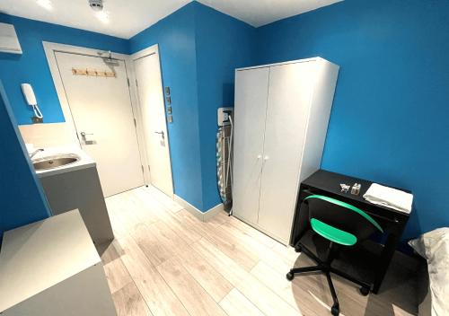 a blue room with a sink and a bathroom at Letzi Ensuite, 15 Min to Heathrow, Fast WiFi in Hayes