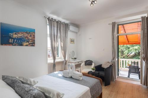 a bedroom with a bed and a large window at Apartment Porat in Dubrovnik