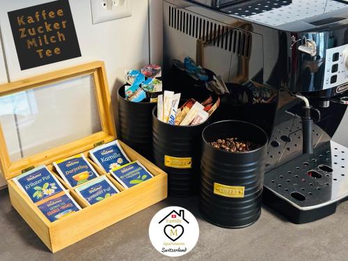 a group of containers of food next to a coffee maker at Family M Apartments 4-5-6 in Kappel bei Olten