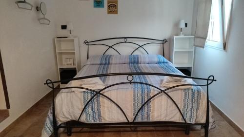 a bedroom with a bed with a wrought iron frame at Darsena b&b tra arte e mare in Ravenna