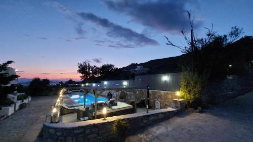 a house with a swimming pool at night at Villa Parisi Naxos & Free Car Rental in Naxos Chora