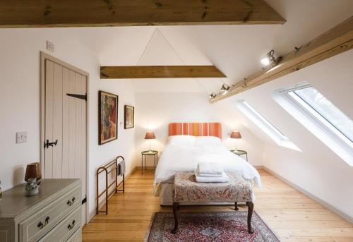 a bedroom with a bed in a attic at Stylish Cottage in the Pewsey Vale in Marlborough