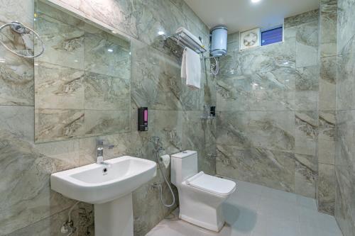a bathroom with a sink and a toilet at The Social Stays Jaipur formerly ArtBuzz in Jaipur