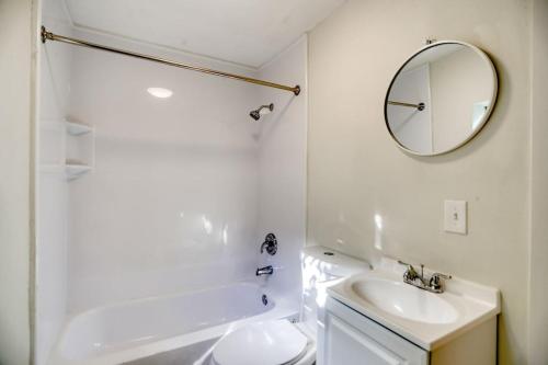 a white bathroom with a sink and a mirror at Stylish, Modern with a splash of Glam! Upscale 4-3 In Historic Coconut Grove in Miami