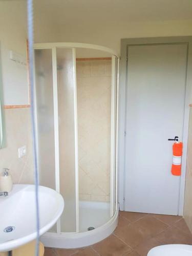 a bathroom with a shower and a toilet and a sink at Villa Oliva in Canino