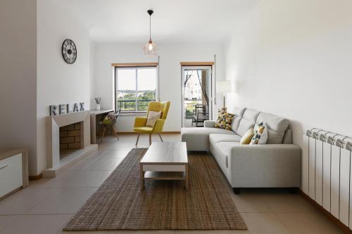 a living room with a couch and a table at Green Hill in Nazaré