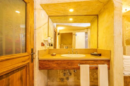 a bathroom with a sink and a mirror at Fresco Cave Suites Cappadocia in Urgup