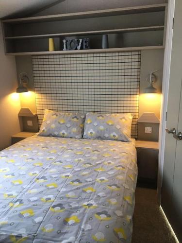 a bedroom with a bed with yellow fish on it at Sterlochy lodge in Boat of Garten