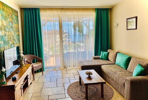 a living room with a couch and a tv at Royal Apartment Sea view by Kaliakria in Topola