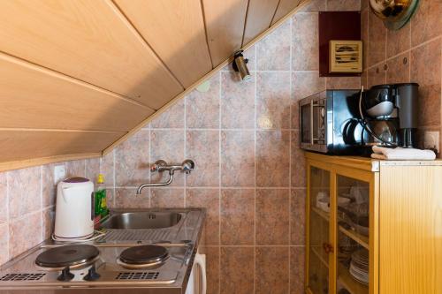 a small kitchen with a sink and a stove at Central Old Town Apartments in Dubrovnik