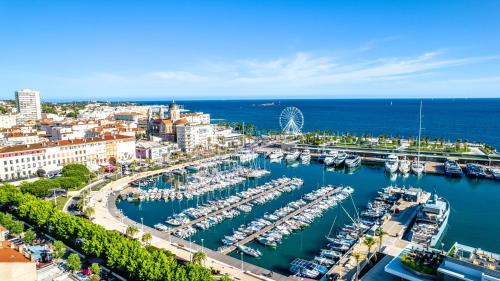 an aerial view of a marina with boats in the water at Hotel Provencal in Saint-Raphaël