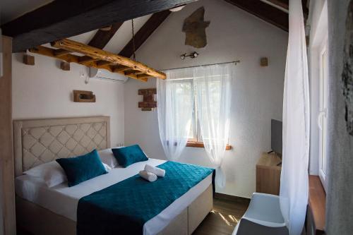 a bedroom with a bed with a teddy bear on it at Holiday Home Moliva in Donje Sitno