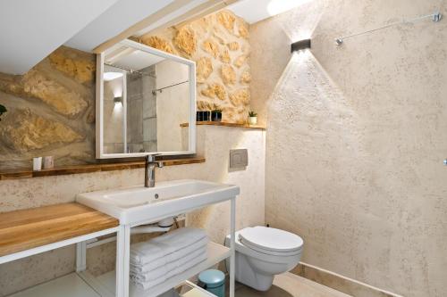 a bathroom with a sink and a toilet at Helios Boutique by La Finca Hotels in Beer Sheva