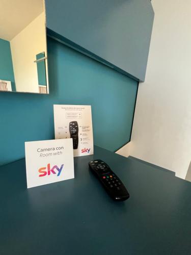 a remote control sitting on a table next to a box at Tabù Hotel in Porto Cesareo
