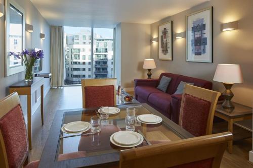 a living room with a table and a couch at Marlin Apartments London Bridge - Empire Square in London