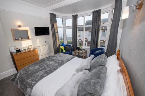 a bedroom with a large bed and a large window at Blantyre Guest House in Bridlington