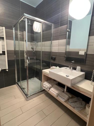 a bathroom with a sink and a shower at Tabù Hotel in Porto Cesareo