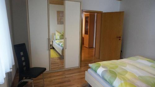 a bedroom with a bed and a large mirror at Ferienwohnung Einberger-Schinabeck in Grafenau