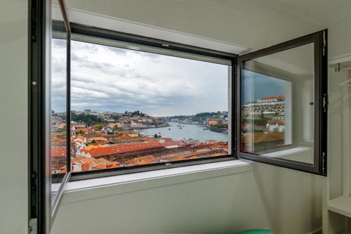a window in a room with a view of a river at Lovely 2BR w/ views over the river, parking incl in Vila Nova de Gaia
