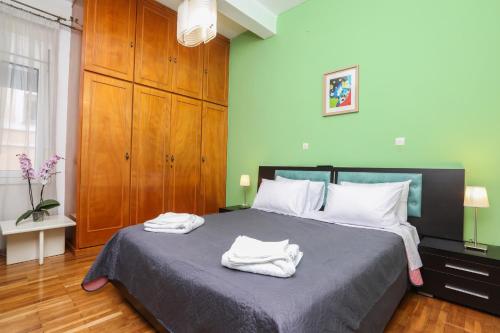 a bedroom with a bed with two towels on it at Irene house tenis club in Agios Rokkos