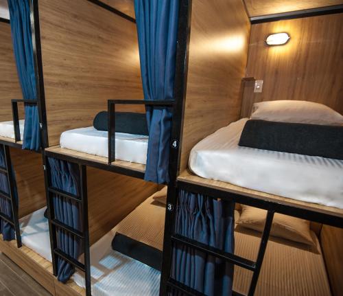 a room with three bunk beds on a boat at Saigon Hub Hostel in Ho Chi Minh City