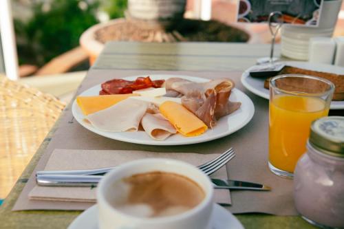 a table with a plate of food and a cup of coffee at Wyndham Residences Costa Adeje in Adeje
