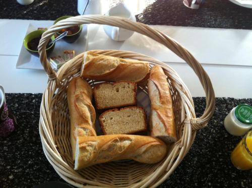 a basket of bread on a counter with at La Vigneraie de Meusnes in Meusnes