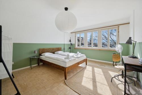 a bedroom with a bed in a room with green walls at Münstergasse Zurich Old Town in Zurich