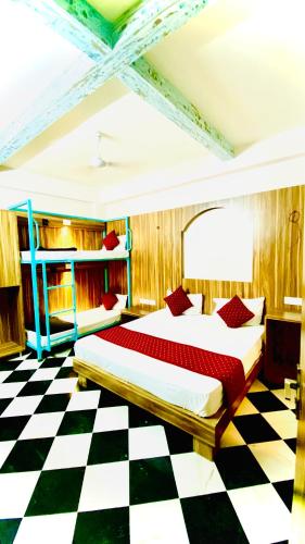 a bedroom with a bed and a checkered floor at The Uddhav Elite in Udaipur