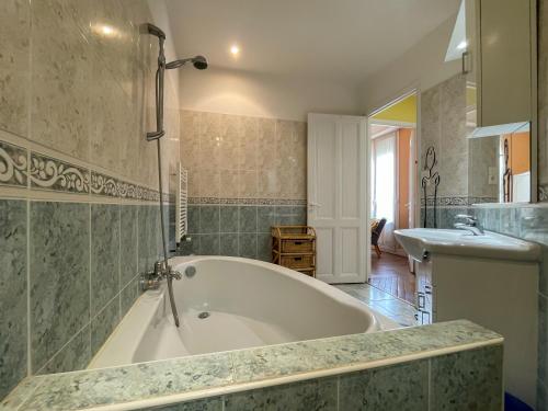 a large bathroom with a tub and a sink at Grosso 4 Pers WiFi AC Parking in Nice