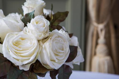 a bouquet of white roses in a vase at Grays Court Hotel in York