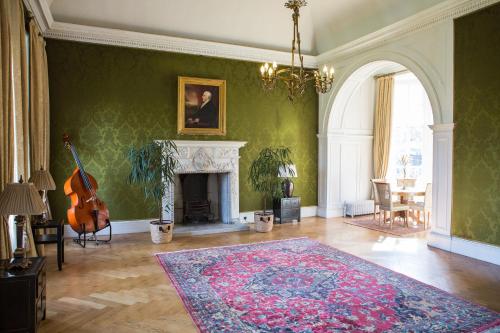 a living room with a fireplace and a violin at Grays Court Hotel in York