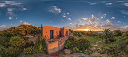 a house on a hill with the sunset in the background at Villa Perenaccio in Corbara