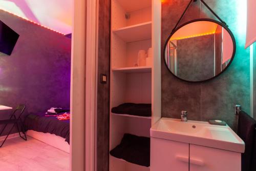 a bathroom with a sink and a mirror at Love Room avec Balnéo in Toulon