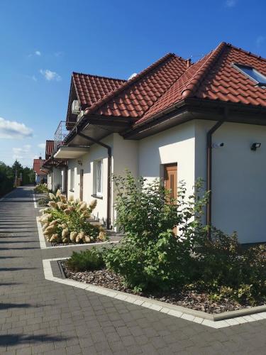 a row of houses on a street at Kalinowy Sen II in Warsaw