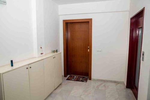 an empty room with a door and a kitchen at Lavrio Seaview 2bdr Apt 4 min dive from the sea in Lávrion