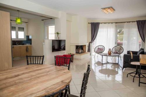 a large living room with a wooden table and a dining room at Lavrio Olympic Marine Seaview 2bdr Apt in Lávrion