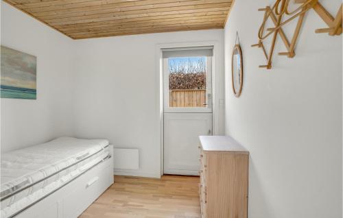 1 dormitorio con cama, ventana y puerta en Nice Home In Dronningmlle With Kitchen, en Dronningmølle