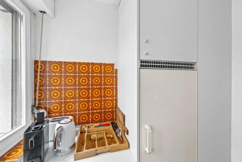 a kitchen with a cutting board on a counter at Muenstergasse Zurich Old Town in Zürich